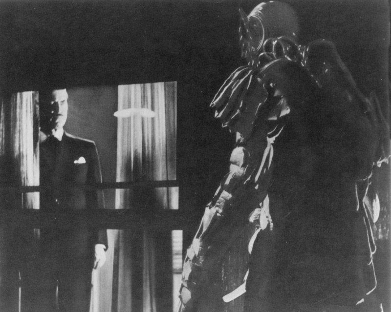 Edward L. Cahn, director, The She-Creature, 1956, motion picture, AIP.  A baleful Dr. Lombardi (Chester Morris) summons the She-Creature (Paul Blaisdell) from inside the home of millionaire businessman Timothy Chappel (Tom Conway). Exploiting a series of gruesome murders, Chappel catapults hypnotist Lombardi into a state of national celebrity. Click to enlarge.
