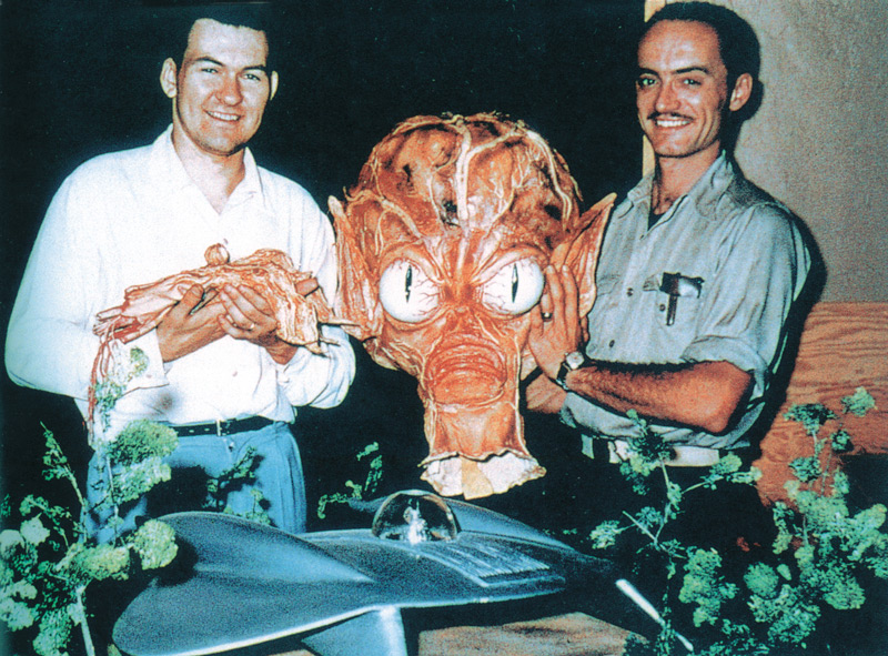 1957, Bob Burns (left) and Paul Blaisdell with parts of a Saucer Man costume and the main flying saucer prop carved by Blaisdell out of white pine for the motion picture Invasion of the Saucer Men, AIP, 1957. Click to enlarge.