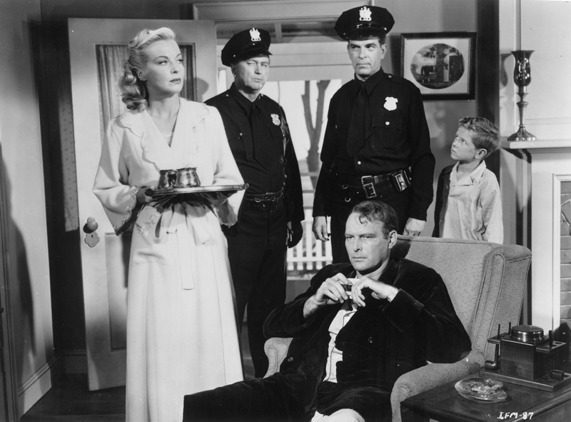 From left to right, Hillary Brooke as Mary MacLean, Charles Kane as Police Officer Blaine, Douglas Kennedy as Officer Jackson, Leif Erickson (seated) as George MacLean, and Jimmy Hunt as the MacLeans' twelve year-old son, David. Click to enlarge.