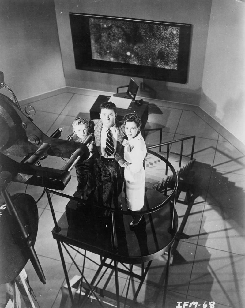 The interior of Kelston's observatory from Invaders from Mars. Left to right, Arthur Franz as astronomer Stuart Kelston, Jimmy Hunt as David MacLean and Helena Carter as psychologist Patricia Blake. Click to enlarge.