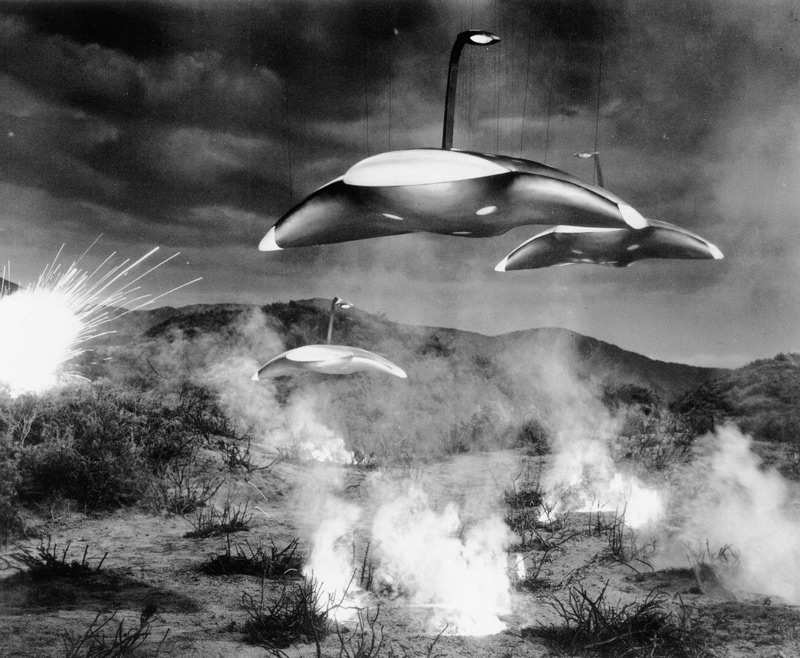 From the gully where the meteor crashed to earth in the film version of The War of the Worlds, three sleek alien ships emerge.  The ships were actually 42 inches in diameter and were suspended by wires like marionettes above a miniature set on Stage 18 at Paramount Studios.  Through the use of trick photography they were made to appear 30 feet wide and suspended from the ground on nearly invisible beams. The beam effect substituted for the articulated mechanical legs of the Martian tripods as they were described in Wells' original 1897 novel. Click to enlarge.