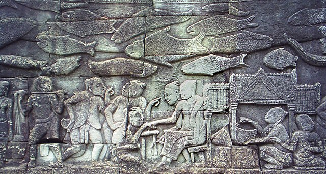 Carving in the southern gallery of Bayon temple depicting Chinese merchants buying from Khmer women