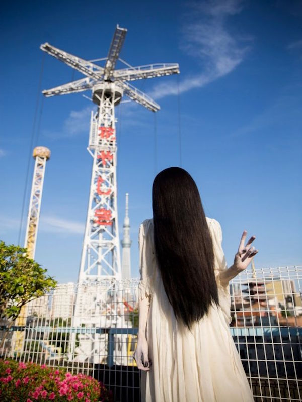 Sadako flashes a peace sign
