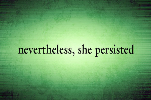 The words "Nevertheless, She Persisted" in black on green.