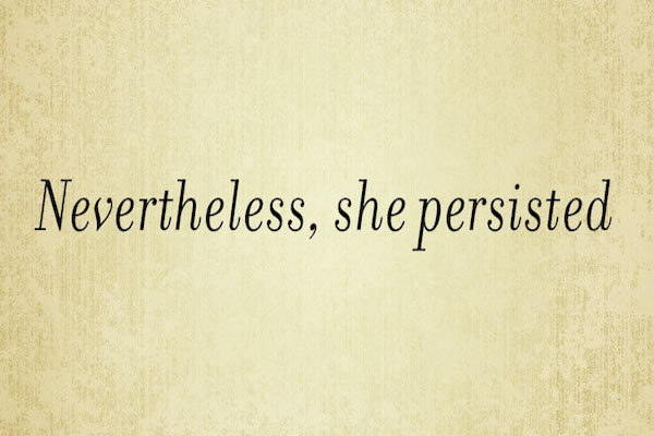 The words "Nevertheless, She Persisted" in dark brown on light brown