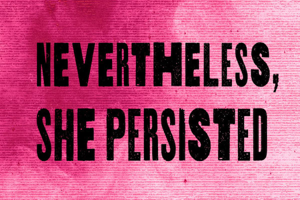 The words "Nevertheless, She Persisted" in black on pink.