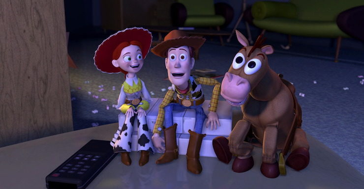 Jessie, Woody, and Bullseye watch Woody's Roundup in Pixar's Toy Story 2