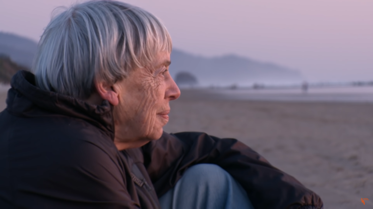 Ursula K. Le Guin staring into the distance on beach