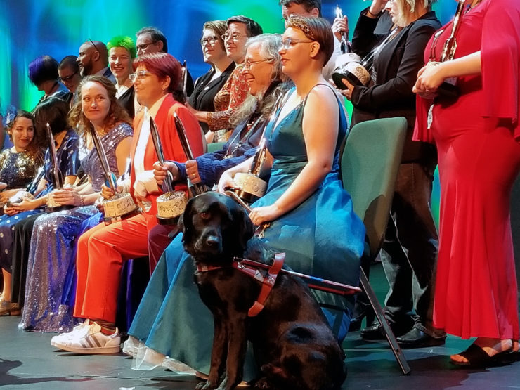 Elsa Sjunneson-Henry and her guide dog, Pax, alongside the asembled 2019 Hugo winners. (Photo: Jonathan Henry)