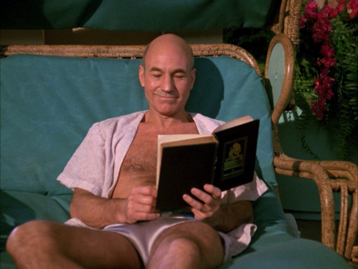 Captain Picard reading a book in TNG episode Captain's Holiday