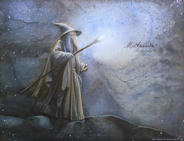 a wizard dressed in grey holds out a glowing staff
