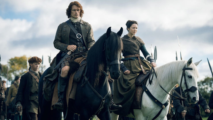 Jamie (Sam Heughan) and Claire (Caitriona Balfe) on horseback in Outlander
