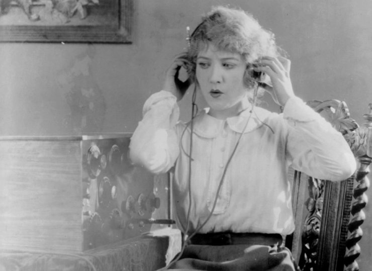 Woman with headphones listening to radio