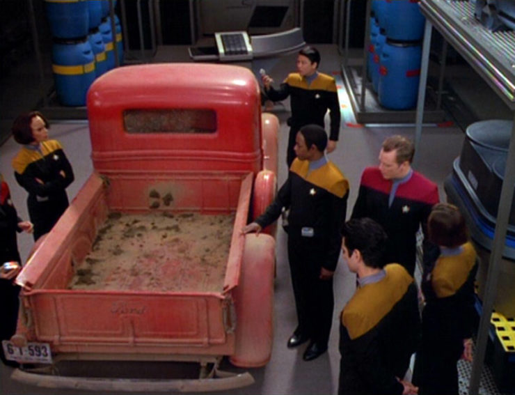The crew surround a 1930s style truck in Star Trek: Voyager