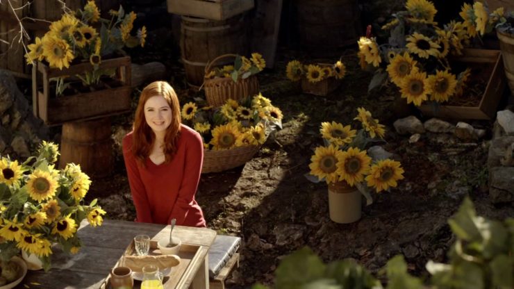 Amy Pond (Karen Gillan) surrounded by sunflowers in Doctor Who