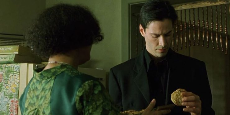 The Oracle (Gloria Foster) gives Neo (Keanu Reeves) a cookie in The Matrix