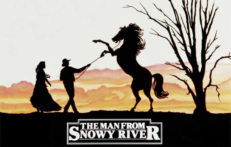 Movie poster for The Man From Snowy River. A man holds the reins of a rearing horse.