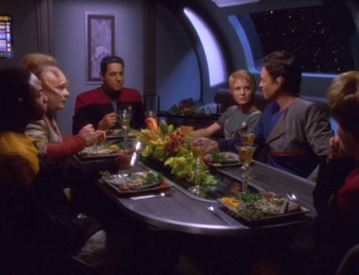The Voyager crew sits around a table in Star Trek: Voyager