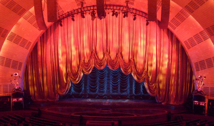 the stage at Radio City Music Hall with the curtain partly raised