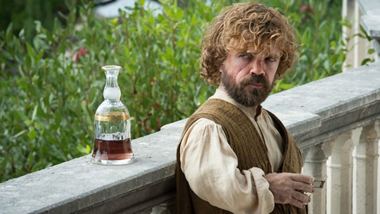 Game of Thrones Tyrion standing near a bottle of liquor