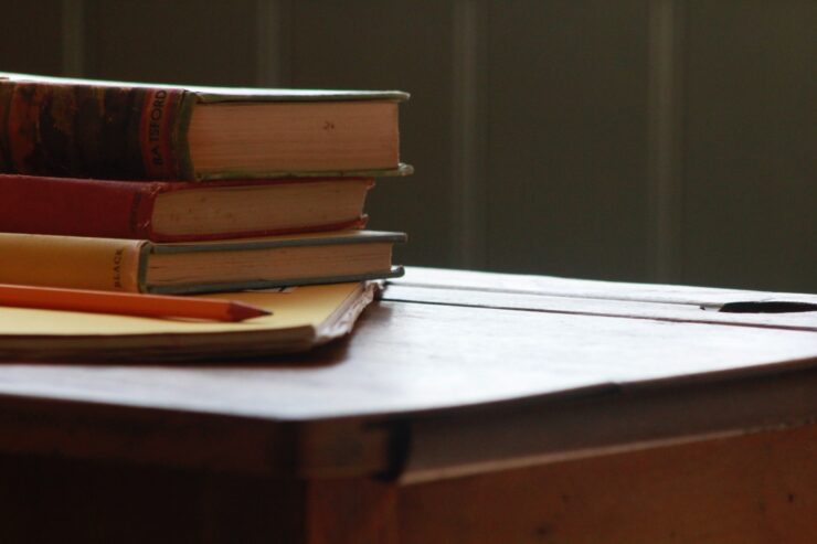 stack of books on top of a school desk
