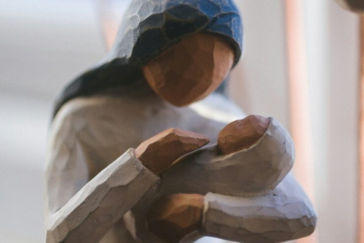 Close-up abstract figurine of a mother holding a swaddled infant
