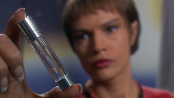 T'Pol holds a vial containing several hairs in a screenshot from Star Trek: Enterprise "Demons"