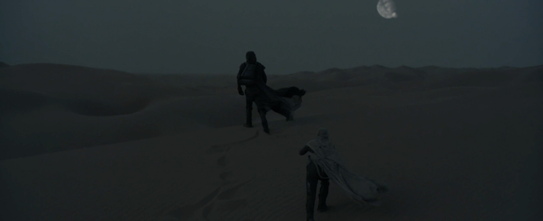 Paul and Jessica walk through the Arrakis desert in a scene from Dune Part One, directed by Deis Villeneuve