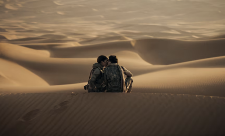 Scene from Dune Part II showing Chani and Paul sitting on a sand dune