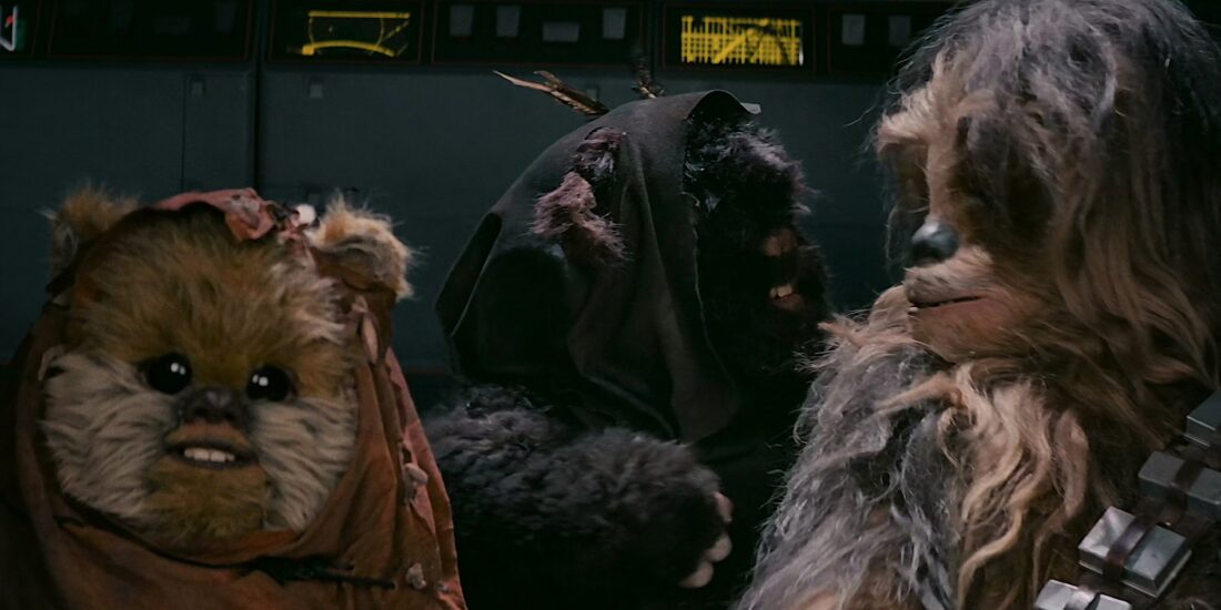 Ewoks sitting in a comandeered AT-ST with Chewie, talking to him