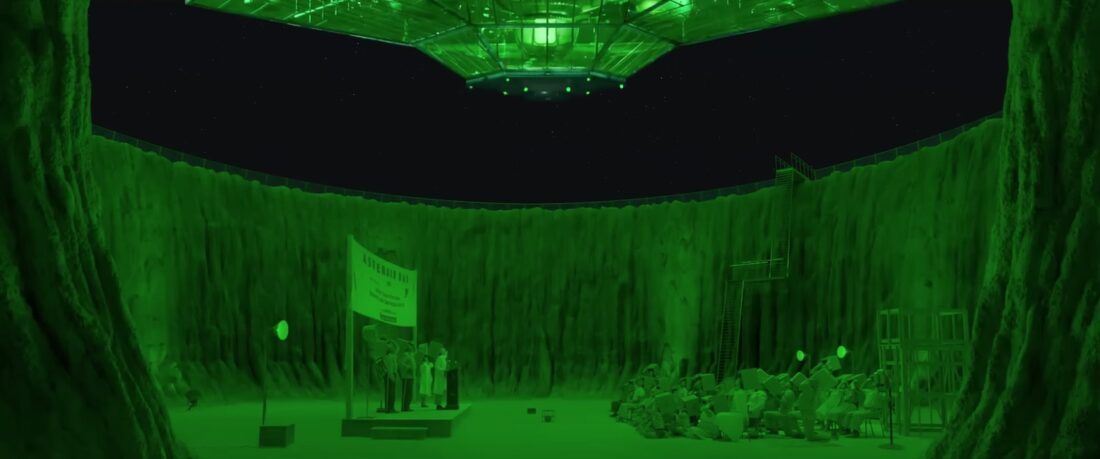 A green-lit spaceship hovers over the cast of Wes Anderson's Asteroid City