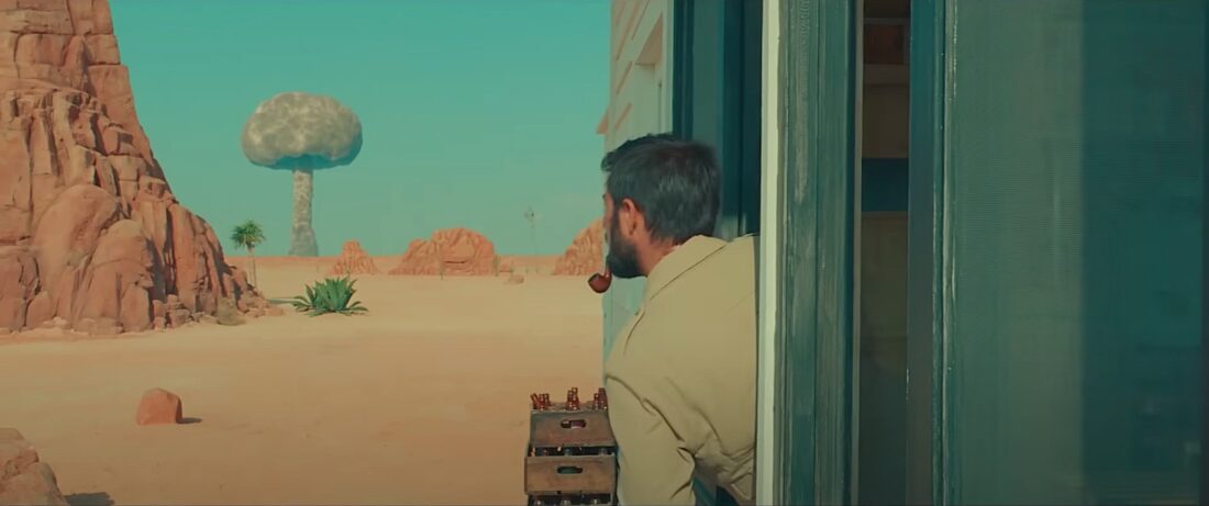 Augie Steenbeck looks at a mushroom cloud on the horizon in Wes Anderson's Asteroid City.