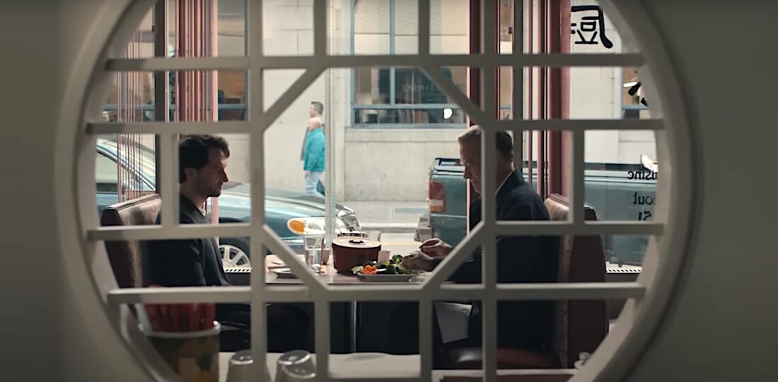 Lloyd Vogel (Matthew Rhys) and Fred Rogers (Tom Hanks) sit across from each other at a table in a restaurant