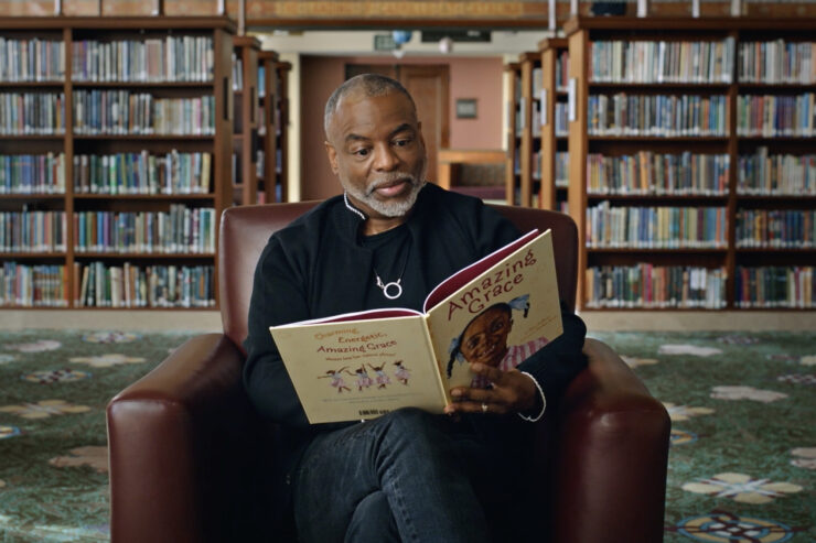 LeVar Burton reading a book in Butterfly in the Sky documentary.