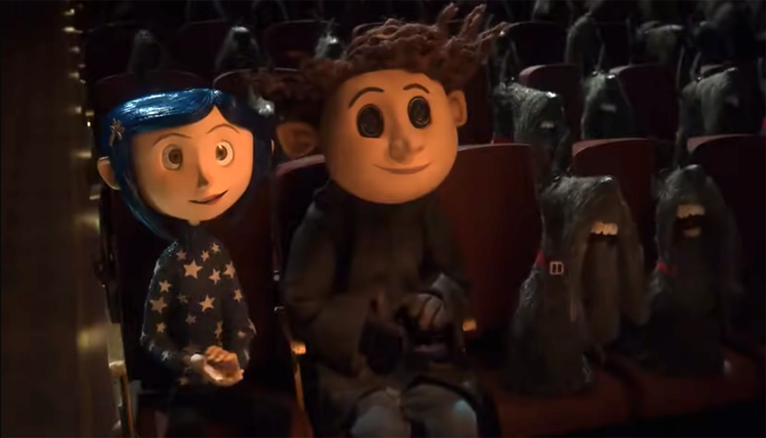 Coraline, Other Wybie, and numerous scottie dogs sit in theater seats in a scene from Coraline