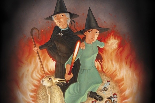 cover of I Shall Wear Midnight showing two witches, a rabbit, and some tiny people in a circle of fire against a dark background.