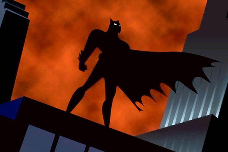 An Batman silhouetted against an orange sky from the opening credits of Batman: The Animated Series