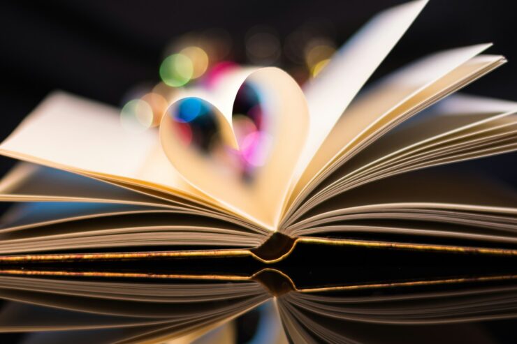 open book with its central pages folded in to form a heart