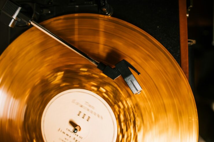 Photo of a yellow record on a record player