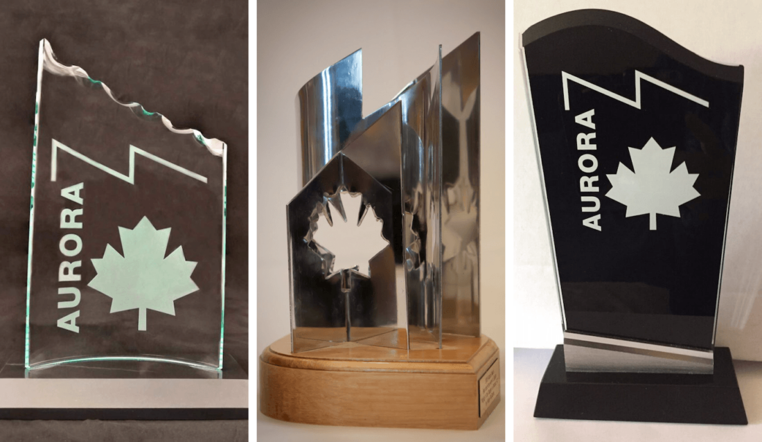 Composite photo showing three different versions of the Aurora Award statue