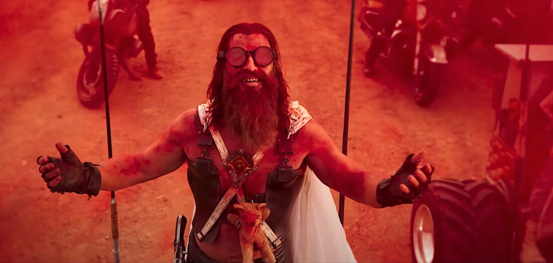 Chris Hemsworth as Dementus is covered in red dye powder in a scene from Furiosa: A Mad Max Saga
