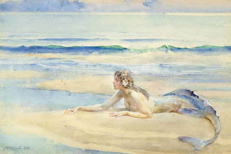 The painting "Mermaid" (1906) by John Reinhard Weguelin, showing a mermaid resting on the sandy beach, just above the blue-green waves of a calm sea. Her tail is blue and curls toward the foreground as she faces left, her right arm outstretched as her left arm supports her. Her hair is fair or light brown, and bound at her neck, while she wears a garland over her ears and crown.