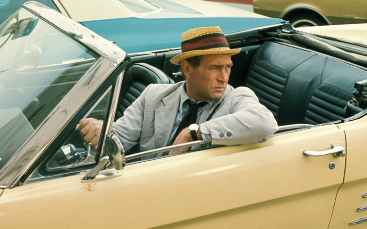 Carl Kolchak (Darren McGavin) drives a pale yellow convertible in an image from the television series Kolchak: The Night Stalker