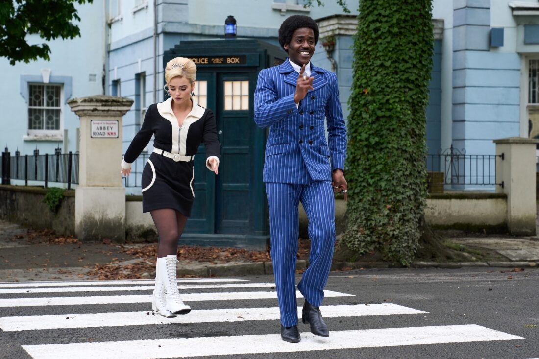 Ncuti Gatwa and Millie Gibson as the Doctor and Ruby on Doctor Who, "The Devil's Chord," walking across Abbey Road in '60s outfits