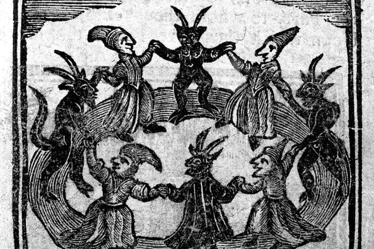 Woodcut print of witches and devils dancing in a circle