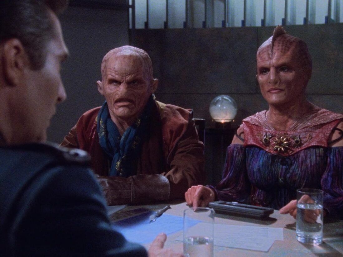 Sinclair speaks with two members of the League of Non-Aligned Worlds in a scene from Babylon 5 "Deathwalker"
