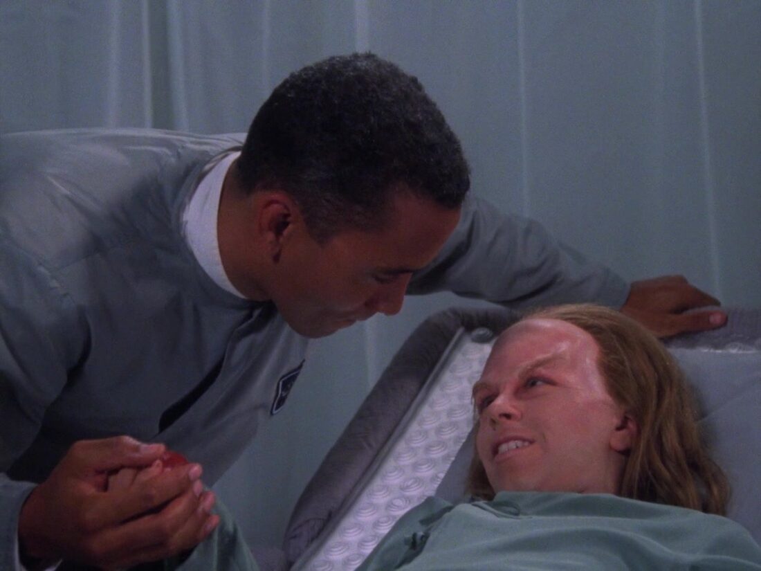 Dr Franklin hands a patient a "glopet egg" in a scene from Babylon 5: Believers
