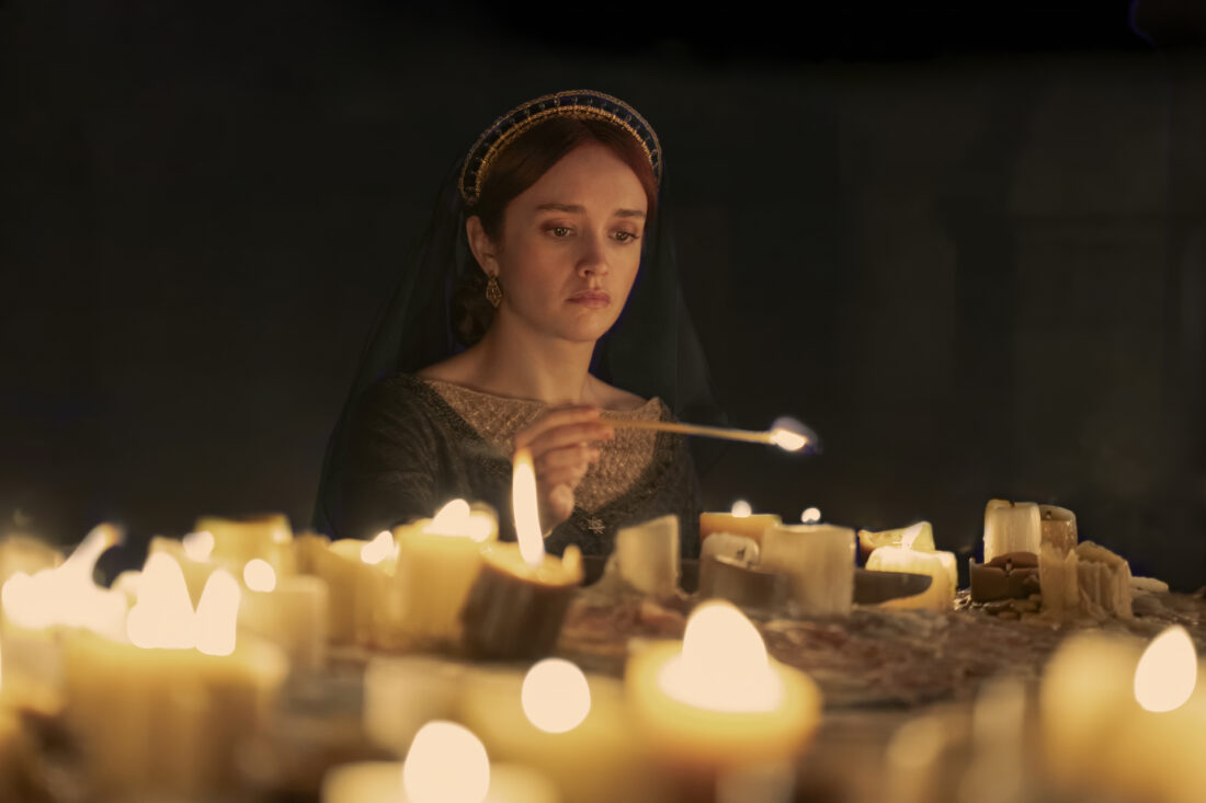 Alicent Hightower (Olivia Cooke) lights candles in a scene from House of the Dragon