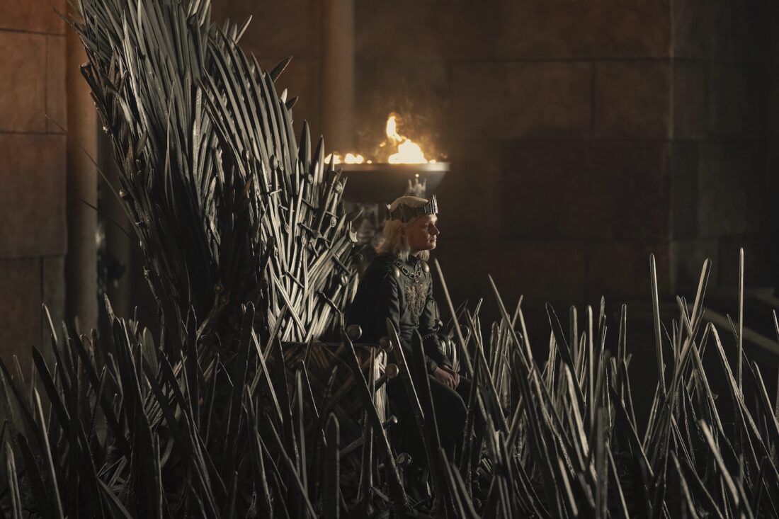 Aegon II Targaryen (Tom Glynn Carney) sits on the iron throne in a scene from House of the Dragon