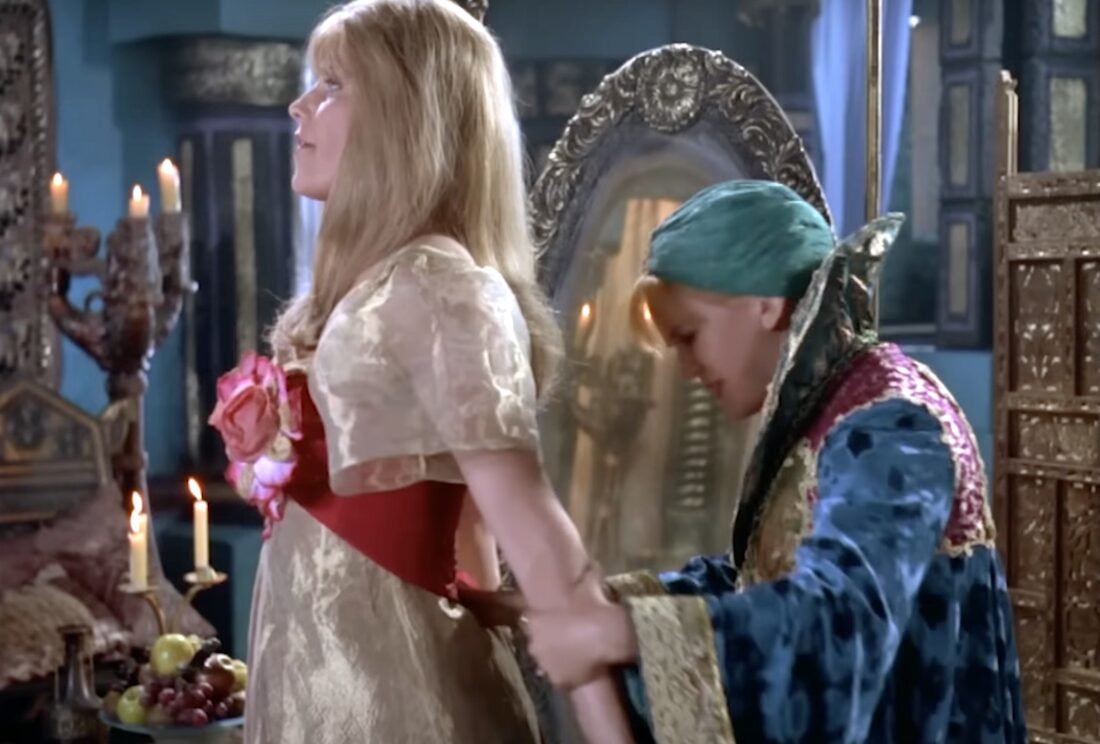 Lucy Lawless as Xena and Renee O'Connor as Gabrielle on Xena: Warrior Princess, S2E11, "Here She Comes... Miss Amphipolis" Gabrielle checks Xena's dress, spinning her around in dismay